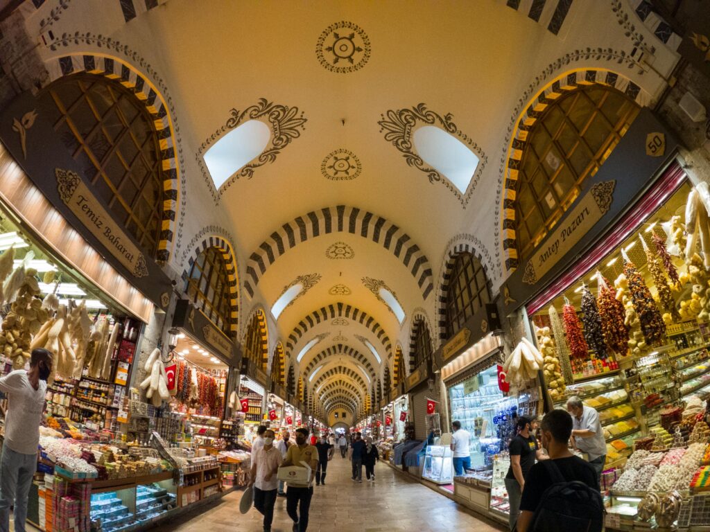 Discover the bustling Spice Bazaar in Istanbul with its arched ceilings and vibrant stalls.