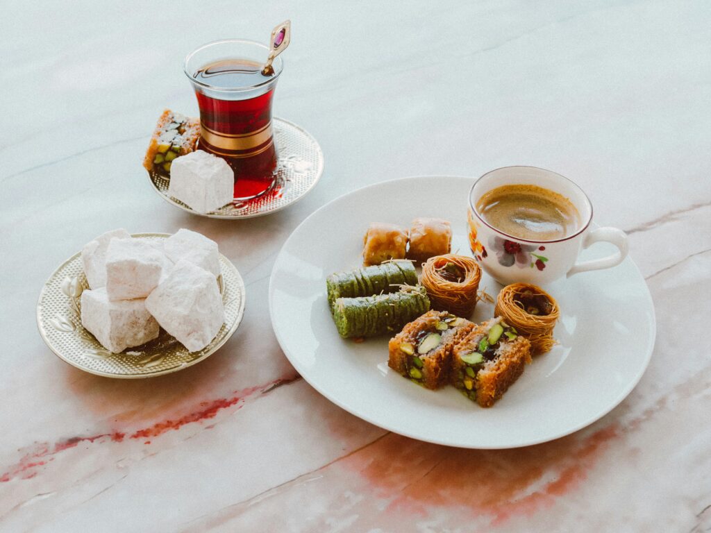 A delightful assortment of baklava and Turkish delight served with coffee and tea, perfect for special occasions.